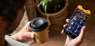 Person holding a phone with the UBC Alumni app open