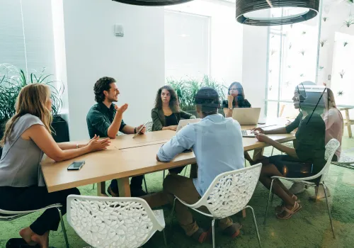 People in a meeting sat around a table