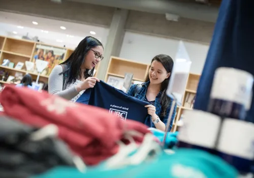 Two students holding a T-shirt