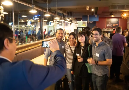 People taking a group photo at a networking event